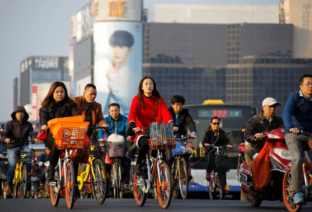 Cyclists during a busy rush hour in the Chinese capital Beijing, China on October 12, 2017. (Photo by Thomas Peter/Reuters)