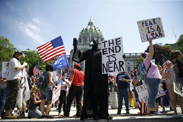 Protesters demonstrate during a rally against Pennsylvania's coronavirus stay-at-home order at the state Capitol in Harrisburg, Pa., Friday, May 15, 2020. (Photo by Matt Rourke/AP Photo)