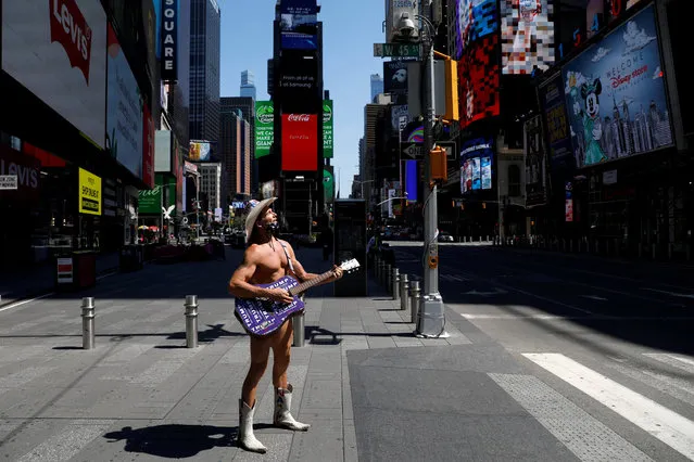 The Naked Cowboy stands alone in Times Square as Broadway theatres extended their closure due the outbreak of the coronavirus disease (COVID-19) in Manhattan, New York City, U.S., May 15, 2020. (Photo by Andrew Kelly/Reuters)