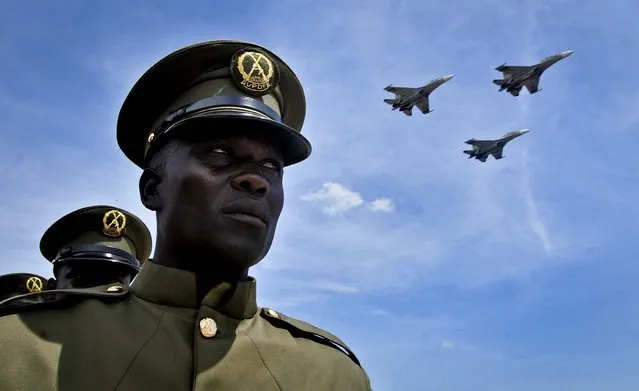 Ugandan jets fly past a military parade of the Uganda People's Defence Force to celebrate the 50th anniversary of the country's independence from British rule, in Kampala, on October 9, 2012. The East African country has come a long way from the days when brutal dictators were in charge, but it has not had a single peaceful transfer of power since 1962, and the potential for instability remains as opposition activists intensify their campaigns and authorities clamp down. (Photo by Stephen Wandera/Associated Press)
