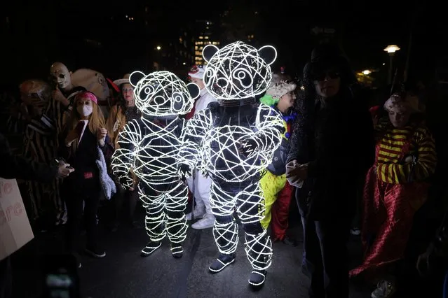 People dress as illuminated panda bears as they attend New York's Annual Village Halloween Parade in Manhattan, New York City, U.S., October 31, 2022. (Photo by Andrew Kelly/Reuters)