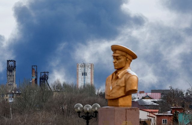 Smoke rises behind a World War Two memorial in the course of Russia-Ukraine conflict in Donetsk, Russian-controlled Ukraine, on February 19, 2024. (Photo by Alexander Ermochenko/Reuters)