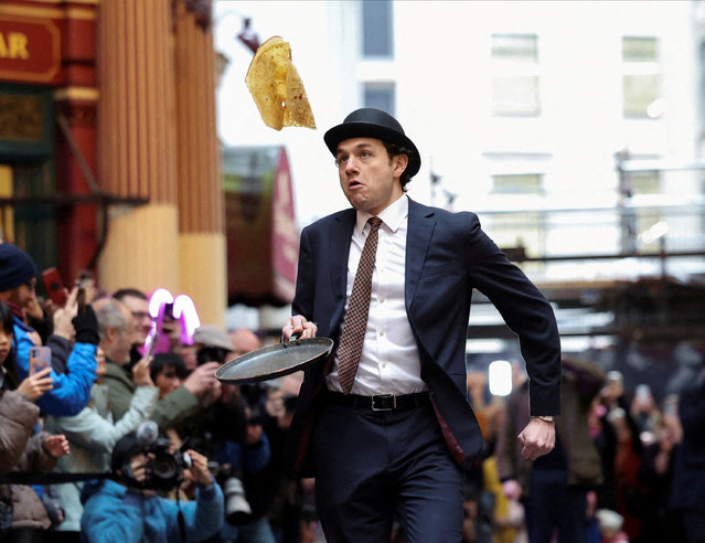 A competitor takes part in the Shrove Tuesday Pancake Race at the City of London's Leadenhall Market, in London, Britain, on February 13, 2024. (Photo by Isabel Infantes/Reuters)