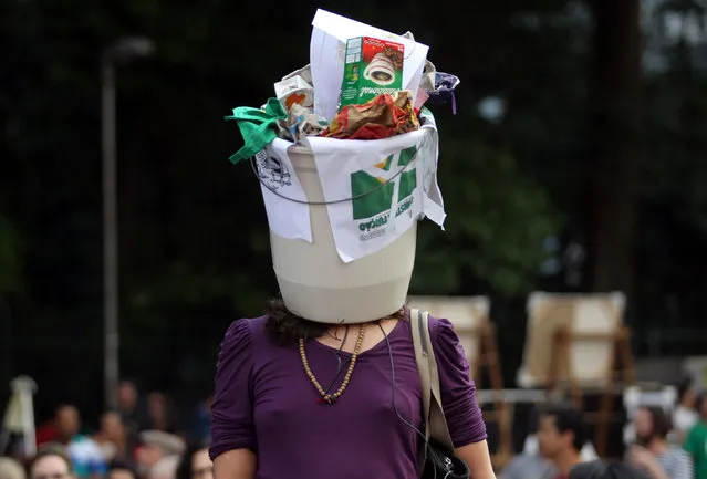 A demonstrator wears a garbage bin on her head during a protest against President Michel Temer in Sao Paulo, Brazil, September 11, 2016. (Photo by Fernando Donasci/Reuters)