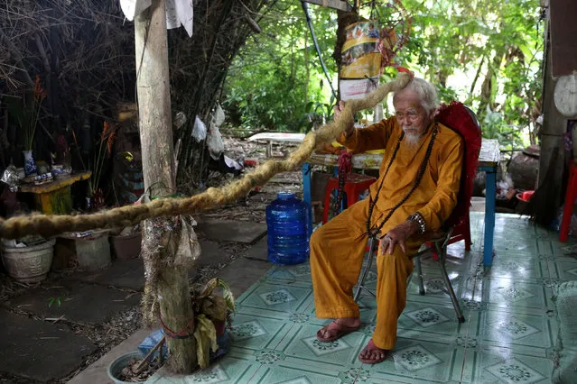 Nguyen Van Chien, 92, sits for a portrait to show his 5-meter long hair which according to him, has not been cut for nearly 80 years, at his home in Tien Giang province, Vietnam, August 21, 2020. (Photo by Yen Duong/Reuters)