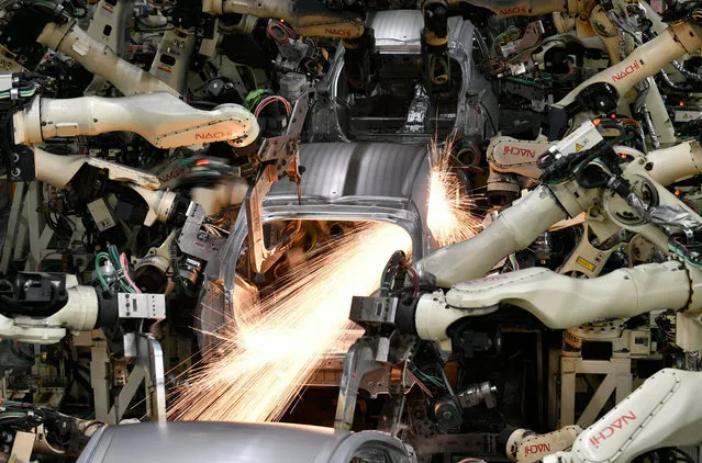Robots weld at the Toyota Tsutsumi car assembly plant in Toyota, near Nagoya, central Japan, 08 December 2017. The fourth-generation of the Prius hybrid vehicle is assembled at the Tsutsumi plant. (Photo by Franck Robichon/EPA/EFE)