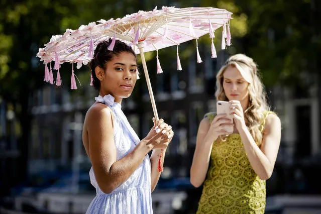 Models pose during the modified ninth edition of the Canal Catwalk, the annual fashion show along the canals of Amsterdam on September 21, 2020. (Photo by Robin van Lonkhuijsen/ANP/AFP Photo)