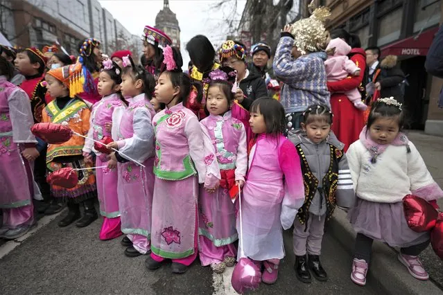 Young girls wait to participate in the Lunar New Year parade, in Vancouver, British Columbia, Sunday, January 22, 2023. (Photo by Darryl Dyck/The Canadian Press via AP Photo)