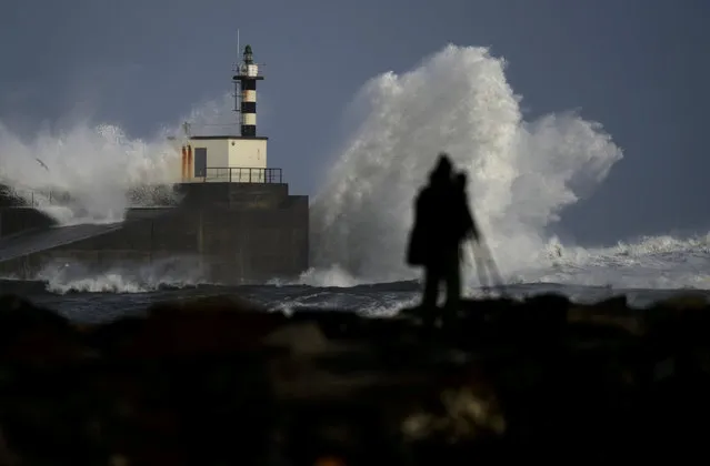 A man takes pictures of waves crashing at the San Esteban de Pravia seafront of the Spanish region of Asturias, December 27, 2017. (Photo by Eloy Alonso/Reuters)