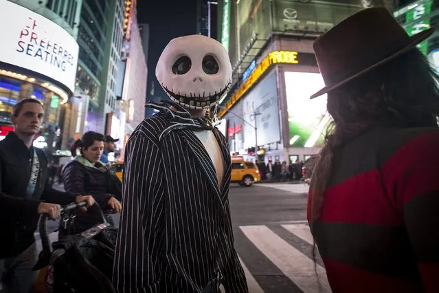 A reveler dressed up for Halloween walks through Times Square in the Manhattan borough of New York October 31, 2015. (Photo by Carlo Allegri/Reuters)