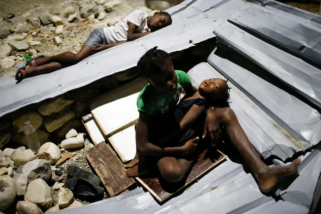 Children sleep over metal sheets in a partially destroyed school used as a shelter after Hurricane Matthew hit Jeremie, Haiti, October 11, 2016. (Photo by Carlos Garcia Rawlins/Reuters)