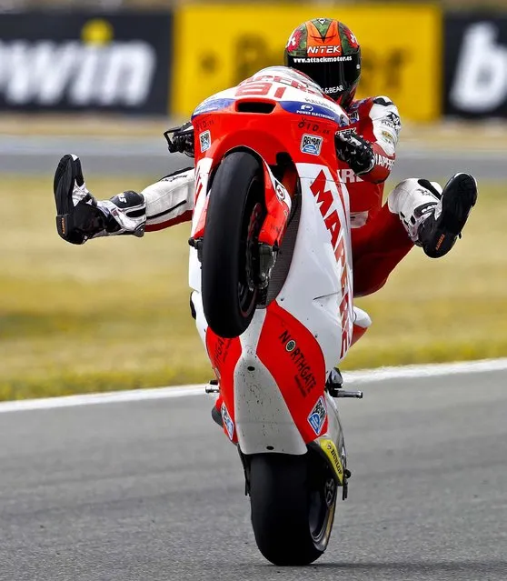 Spanish Moto2 rider Jordi Torres of Mapfre lifts his front wheel during the first free practice session of the Spain MotoGP at the Jerez race track in Spain, ahead of Sunday's Spanish Motorcycle Grand Prix, on May 3, 2013. (Photo by Miguel Angel Morenatti/Associated Press)