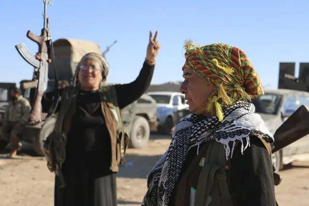 Kurdish guard women from the civilian protection unit which supports the Democratic Forces of Syria, cheer near the Syrian town of al Houl in Hasaka province, after the Democratic Forces of Syria took control of the area, November 14, 2015. (Photo by Rodi Said/Reuters)