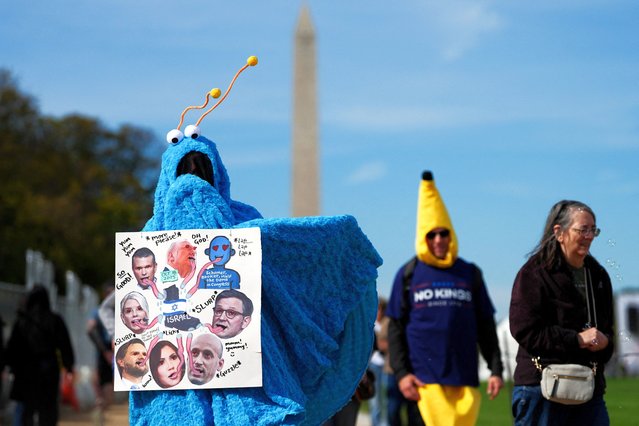 A demonstrator wearing a The Martians from Sesame Street costume holds a placard depicting U.S. President Donald Trump, U.S. Secretary of Defense Pete Hegseth, U.S. Attorney General Pam Bondi, U.S Vice President JD Vance, U.S. Homeland Security Secretary Kristi Noem, White House Deputy Chief of Staff Stephen Miller and U.S. House Speaker Mike Johnson as people march down the National Mall to take part in a “No Kings” protest against U.S. President Donald Trump's policies, in Washington, D.C., U.S., October 18, 2025. (Photo by Leah Millis/Reuters)