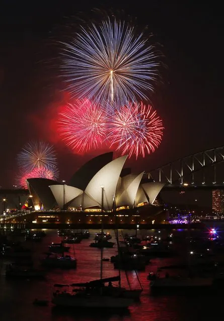 Fireworks light up the Sydney Opera House and Harbour Bridge during an early light show before the midnight New Year fireworks, December 31, 2014. (Photo by Jason Reed/Reuters)