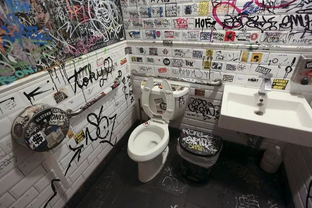 Graffiti is painted on the bathroom walls at a restaurant in the Williamsburg area of Brooklyn borough in New York, United States, October 1, 2015. (Photo by Shannon Stapleton/Reuters)