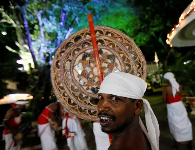 A traditional dancer looks on before the annual Sri Dalada Perahera (street parade) at a Buddhist temple in Colombo, Sri Lanka September 7, 2016. (Photo by Dinuka Liyanawatte/Reuters)