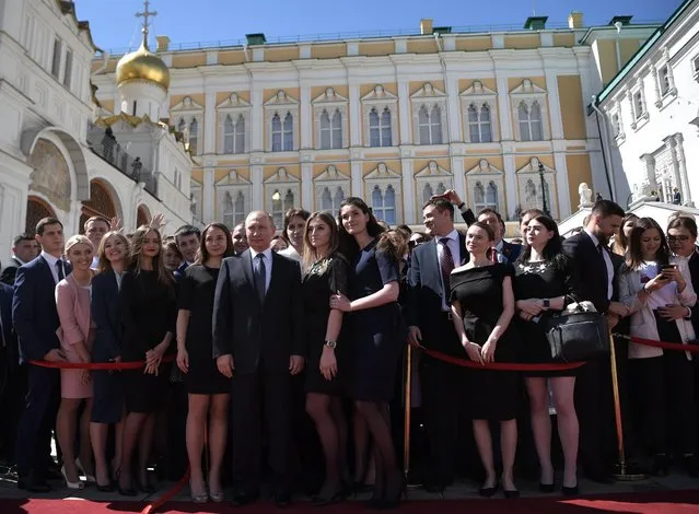 Russian President Vladimir Putin (C) poses for a picture with guess who were invited to his inauguration ceremony in the Cathedral Square in the Kremlin in Moscow, Russia, 07 May 2018. Vladimir Putin won his fourth term in the Kremlin during presidential elections on 18 March 2018. (Photo by Alexey Nikolsky/EPA/EFE)