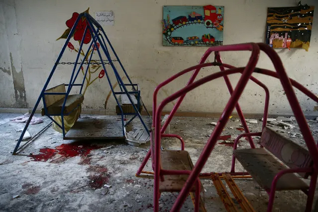Blood stains the ground under swings in a damaged kindergarten after an air strike in the rebel-held besieged city of Harasta, in the eastern Damascus suburb of Ghouta, Syria November 6, 2016. (Photo by Bassam Khabieh/Reuters)