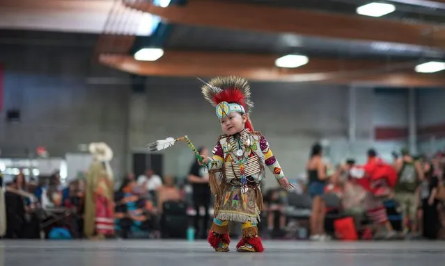 Akio Pierro, 2, of the Bonaparte First Nation, dances before the grand entry at the Trout Lake Mother's Day Traditional Pow Wow, in Vancouver, British Columbia, Saturday, May 13, 2023. (Photo by Darryl Dyck/The Canadian Press via AP Photo)