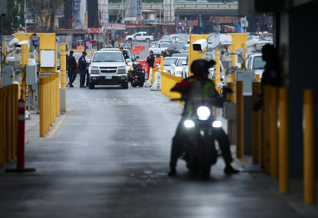 U.S. customs and border patrol officers inspect a vehicle entering the U.S. from Mexico at the border crossing in San Ysidro, California, United States, October 14, 2016. Building a wall along the U.S.- Mexico border has been a contentious subject in this year's U.S. presidential election. In parts of California and Arizona, a wall already exists. It runs across rocky deserts, flowing sand dunes and miles of agricultural land. The wall splits towns and families, marking a boundary between two countries that used to be one. Busy land ports of entry and signs written in both Spanish and English attest to an interdependence that still exists in the bifurcated cities, faded mining towns and eccentric art outposts that punctuate the arid landscape. The border between Mexico and the United States spans some 2,000 miles between San Diego, California and Brownsville, Texas. (Photo by Mike Blake/Reuters)