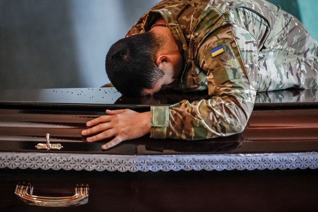 A brother-in-arm of Nolan Durie, 21-year-old Canadian and serviceman of a foreign volunteer unit of the 3rd Separate Assault Brigade, who was killed in on the front line in a fight against Russian troops, reacts as he attends a farewell ceremony for him, in Kyiv, Ukraine on November 3, 2025. (Photo by Alina Smutko/Reuters)