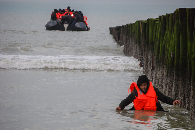 A migrant returns to shore after attempting to cross the English Channel to reach Great Britain on a smuggler's inflatable dinghy at Sangatte beach near Calais, northern France, on January 15, 2025. Around fifty migrants, including a child, on January 15, 2025 attempted to leave France to reach Great Britain via Sangatte beach. (Photo by Bernard Barron/AFP Photo)