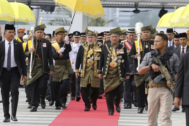 Malaysia King Sultan Muhammad V, center, walks to parliament building for the opening of the 14th parliament session at the Parliament house in Kuala Lumpur, Malaysia, Tuesday, July 17, 2018. The swearing-in ceremony of 221 lawmakers on Monday marked the start of the first parliament session after Najib's long-ruling coalition was ousted in May 9 elections, ushering in Malaysia's first change of power since independence from Britain in 1957. Prime Minister Mahathir Mohamad, the world's oldest leader at 93, made a return to parliament since 2003 when he retired after 22 years in office. (Photo by Yam G-Jun/AP Photo)