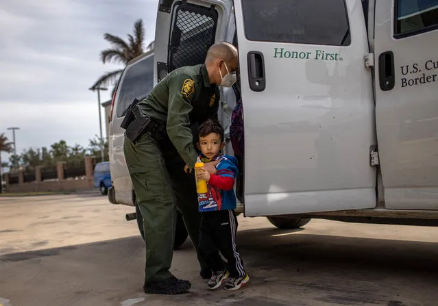 A U.S. Border Patrol agent delivers a young asylum seeker and his family to a bus station on February 26, 2021 in Brownsville, Texas. U.S. immigration authorities are now releasing many asylum seeking families after detaining them while crossing the U.S.-Mexico border.  The immigrant families are then free to travel to destinations throughout the U.S. while awaiting asylum hearings.  (Photo by John Moore/Getty Images)