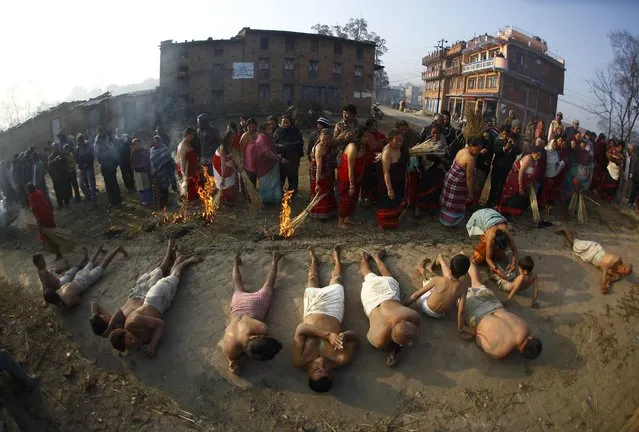 Devotees offer prayer by rolling on the street during the final day of the month-long Swasthani festival at Bhaktapur, near Kathmandu, February 3, 2015. (Photo by Navesh Chitrakar/Reuters)