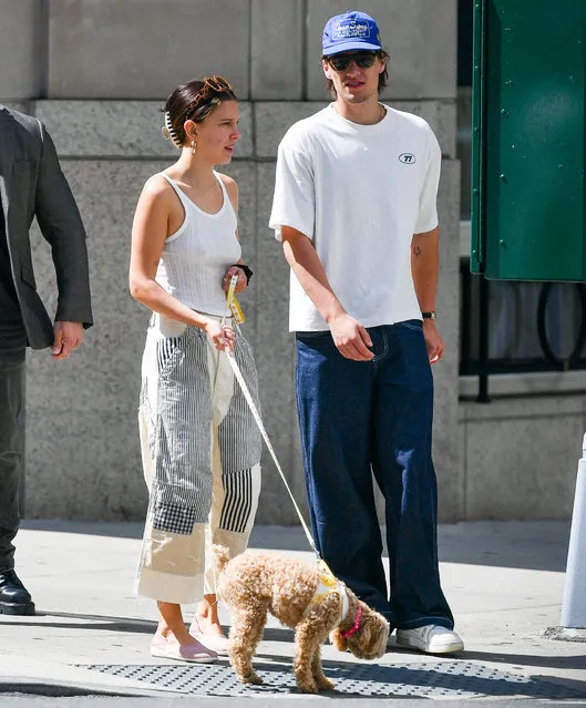 Millie Bobby Brown and Jake Bongiovi are spotted on a family dog walk in New York City on June 28, 2023. The engaged couple were joined by Jake's brother, Romeo, and Millie's parents. The 19 year old Stranger Things star wore a tank top, patched trousers, and lavender flats. (Photo by The Image Direct)