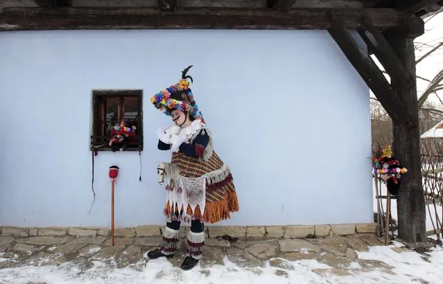 A reveller prepares for a traditional carnival celebrating the departing winter and forthcoming spring at an open-air museum in the village of Vesely Kopec, near the east Bohemian city of Hlinsko, January 31, 2015. (Photo by David W. Cerny/Reuters)