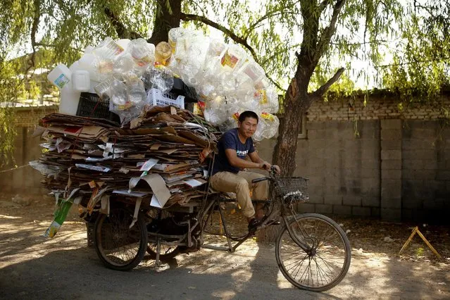 Scrap collector Huang delivers recyclables on a tricycle to a recycling yard at the edge of Beijing, China, August 30, 2016. (Photo by Thomas Peter/Reuters)
