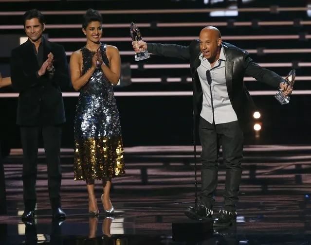 Vin Diesel accepts the awards for favorite movie and for favorite action movie for "Furious 7" as presenters John Stamos and Priyanka Chopra applaud at the People's Choice Awards 2016 in Los Angeles, California January 6, 2016. (Photo by Mario Anzuoni/Reuters)