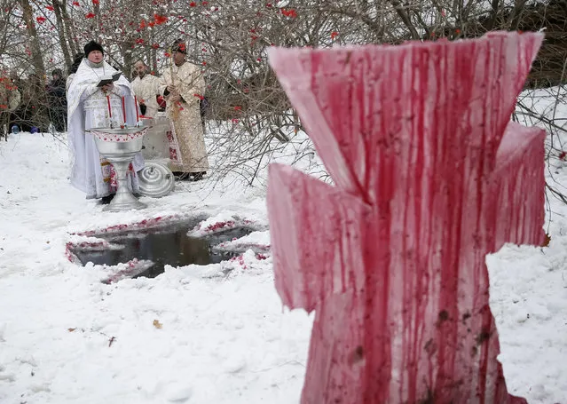 Priests take part in a religious ceremony during Orthodox Epiphany celebrations in Kiev, Ukraine, January 19, 2016. (Photo by Gleb Garanich/Reuters)