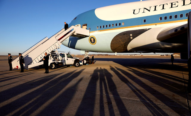 Late afternoon shadows are cast as U.S. President Donald Trump descends the steps of Air Force One upon his return to Joint Base Andrews in Maryland, U.S., January 18, 2018. (Photo by Kevin Lamarque/Reuters)