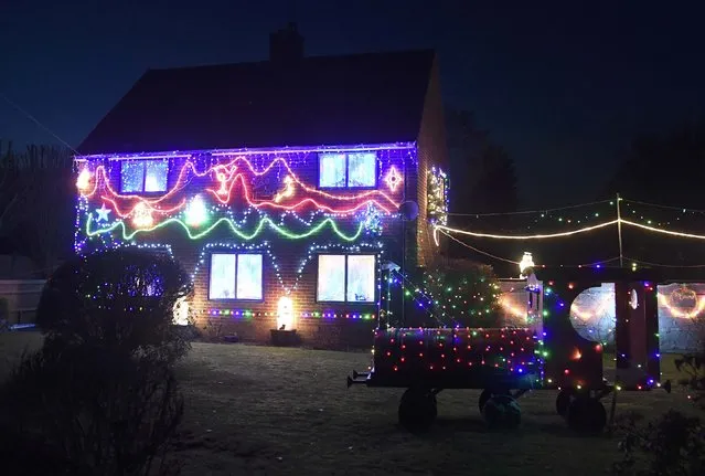 A home is decorated with a display of  Christmas of lights in a tradition that has grown over recent years in the small village of Westfield in Sussex, south east England, December 15, 2016. (Photo by Toby Melville/Reuters)