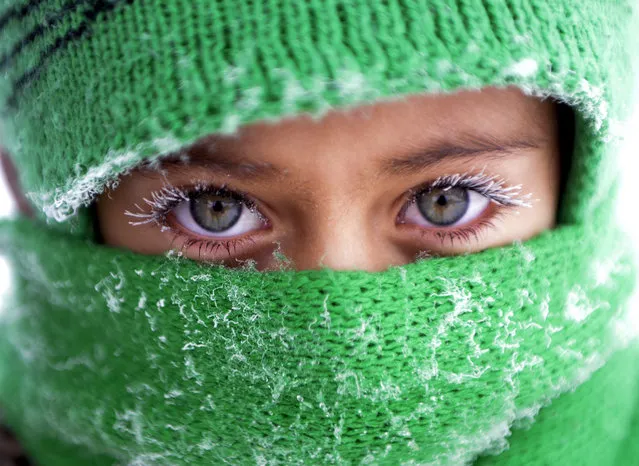 A child, whose eyelash frozen due to the cold weather while she goes to school, poses for a photo at –28 Celcius in Ardahan, Turkey on December 20, 2016. (Photo by Gunay Nuh/Anadolu Agency/Getty Images)