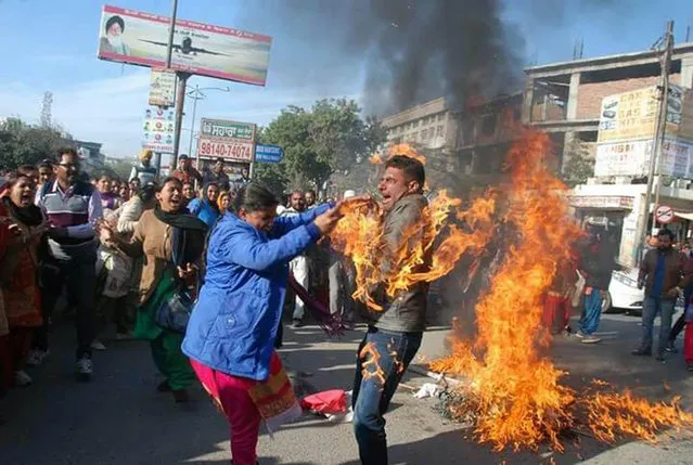 A protester caught on accidental fire during burning of the effigy of Punjab government by contractual teachers appointed under education guarantee scheme at Fauji Chowk, on December 21, 2016 in Bathinda, Punjab, India. The victim has been identified as Sukhminder Singh Mann and was immediately rushed to a local civil hospital. The incident happened when he was sprinkling petrol to burn the effigy. The teachers rued that the Punjab government has not regularised their services even after them completing two-year contract with the state government. The union members claimed that the government had made a two-year contract with more than 7,000 EGS/AIE/STR volunteers in 2014 and promised to regularise their services after completion of the agreement. (Photo by Ajay Verma/Barcroft Images)