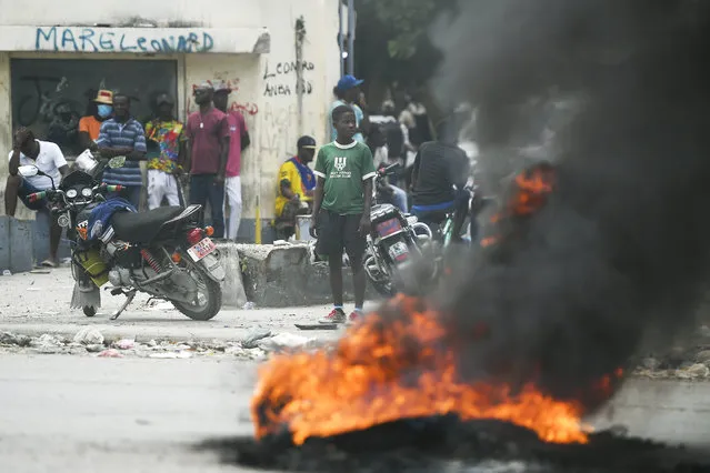 A tire set on fire by supporters of former Senators Youri Latortue and Steven Benoit outside the courthouse in Port-au-Prince, Monday, July 12, 2021. (Photo by Matias Delacroix/AP Photo)