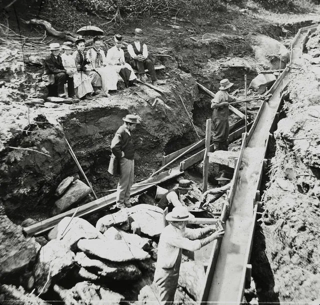 In this 1887 photo provided by the Plymouth Historical Society, a small audience watches men setting up a long box for gold prospecting in a stream in the Five Corners area of Plymouth, Vt. A growing number of people, especially in New England and the Pacific Northwest, are returning to streams in search of gold. (Photo by E.G. Davis collection/Plymouth Historical Society via AP Photo)