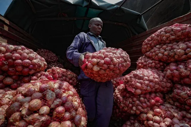 Timothy Kinyua unloads sacks of onions from Ethiopia at an open market in Nairobi, Kenya Tuesday, September 12, 2023. Restrictions on the export of the vegetable by neighboring Tanzania has led prices to triple. The prices for onions from Tanzania were the highest in seven years, Kinyua said. Some traders have adjusted by getting produce from Ethiopia. (Photo by Brian Inganga/AP Photo)