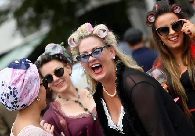 Motoring enthusiasts attend the Goodwood Revival, a three-day historic car racing festival in Goodwood, Chichester, southern Britain, September 17, 2021. (Photo by Toby Melville/Reuters)