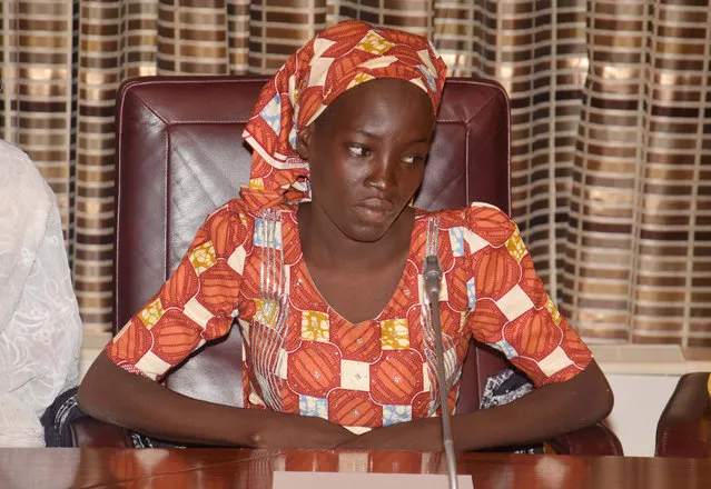 In this Thursday, May 19, 2016 file photo, Amina Ali, the rescue Chibok school girl, sits during a meeting with Nigeria's President Muhammadu Buhari at the Presidential palace in Abuja, Nigeria. Nigeria's Bring Back Our Girls movement demanded Wednesday, June. 22, 2016 that the government provide news of the only one of 219 kidnapped schoolgirls to escape the clutches of the Boko Haram extremist group. (Photo by Azeez Akunleyan/AP Photo)