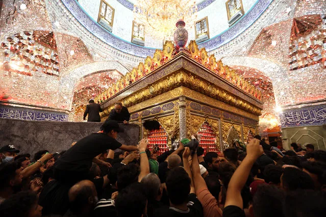 Shiite worshipers react during the religious ceremony of Arbain near the tomb of Imam Hussain at the holy city of Karbala, southern Iraq, 26 September 2021 (issued on 27 September 2021). Iraqi Shiite Muslims gathered in the holy city of Karbala to perform the religious ceremony of Arbain, on the 40th day after the Shiite holy day of Ashura which commemorates the death of Imam Hussein at the battle of Karbala, while Iraqi security forces imposed tight security measures to protect the ceremony. (Photo by Ahmed Jalil/EPA/EFE)