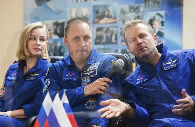 In this handout photo released by Roscosmos, actress Yulia Peresild, left, director Klim Shipenko, right, and cosmonaut Anton Shkaplerov, members of the prime crew of Soyuz MS-19 spaceship attend a news conference at the Russian launch facility in the Baikonur Cosmodrome, Kazakhstan, Monday, October 4, 2021. In a historic first, Russia is set to launch an actress and a film director to space to make a feature film in orbit. Actress Yulia Peresild and director Klim Shipenko are set to blast off Tuesday for the International Space Station in a Russian Soyuz spacecraft together with Anton Shkaplerov, a veteran of three space missions.(Photo by Roscosmos Space Agency via AP Photo)