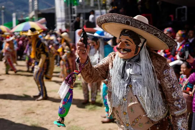 Dancers perform at a celebration honoring Saint Thomas, the patron saint of Chichicastenango in Guatemala, Thursday, December 21, 2023. (Photo by Moises Castillo/AP Photo)