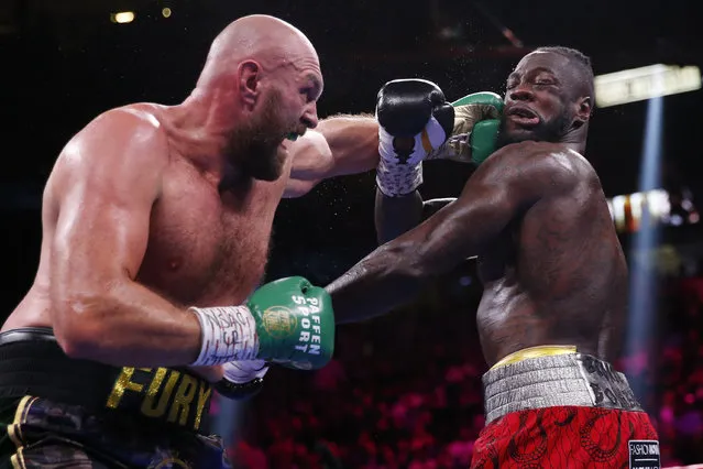 Tyson Fury, of England, lands a left to Deontay Wilder in a heavyweight championship boxing match Saturday, October 9, 2021, in Las Vegas. (Photo by Chase Stevens/AP Photo)