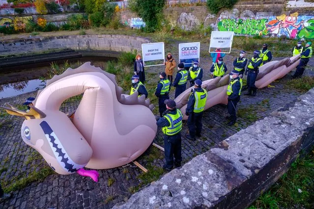 Police detain an inflated sea monster during COP26 on the 2nd of November 2021 in Glasgow, Scotland on November 3, 2021. At dawn the Metropolitan Police stopped a Jubilee Debt Campaign protest and detained a partially inflated Loch Ness monster. The monster represents the debt burden many lower income countries face, making a just climate change transition very difficult. Eva Watkinson, Head of Campaigns at Jubilee Debt Campaign says: The debt crisis facing lower income countries has been excluded from debate at COP26 and now police have prevent the Loch Ness Monster from raising awareness of this fundamental issue. Unsustainable debts of lower income countries are preventing countries from fighting the climate crisis. And when climate disasters hit, countries are pushed into further debt to pay for reconstruction. Rich polluting countries created the climate crisis and should take responsibility by cancelling the debts of countries that need it and ensuring climate finance is given in grants, not more loans. The inflateable monster was subsequently taken away. No arrest were made. (Photo by Jess Hurd/PA Wire Press Association)