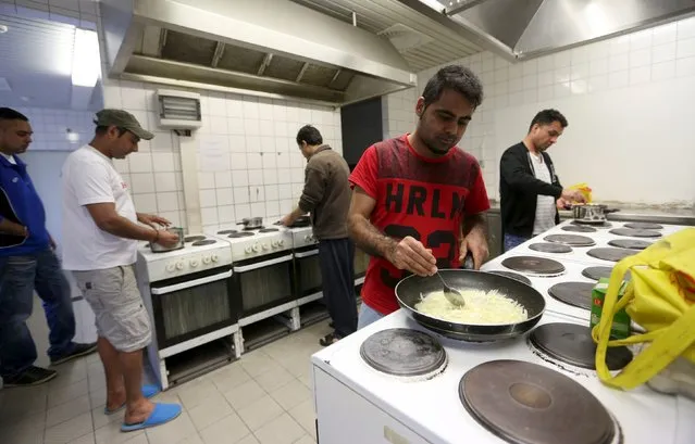 Migrants cook in the kitchen of the accommodation for migrants “Spree Hotel” in Bautzen, Germany, March 24, 2016. The accommodation “Spree Hotel” is a former a four-star hotel and was turned into a home for 240 refugees by owner Peter Kilian Rausch in 2014. (Photo by Ina Fassbender/Reuters)